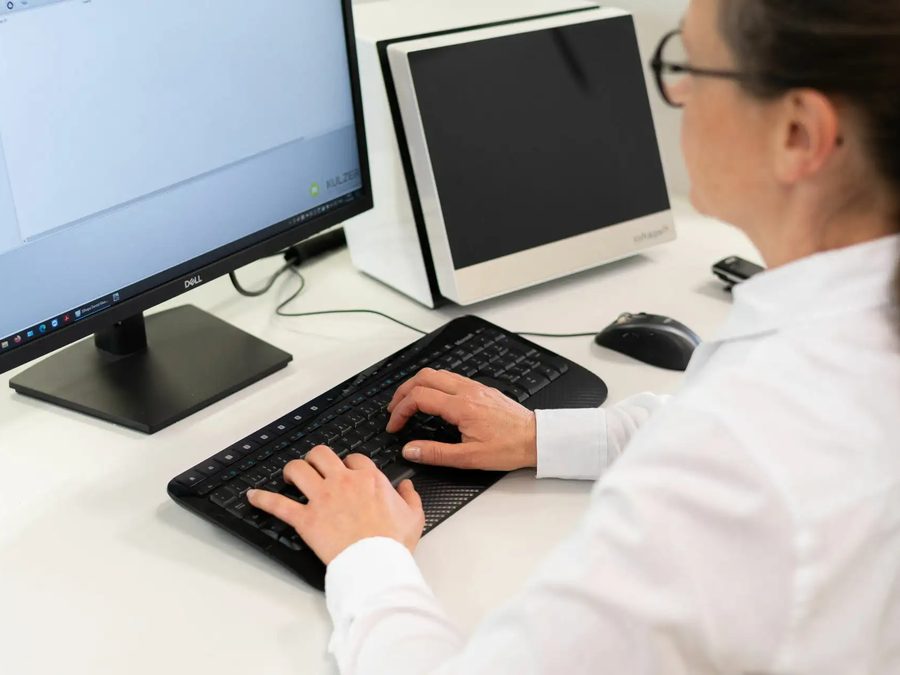 Kollegin sichtet Bewerbungsunterlagen am Computer